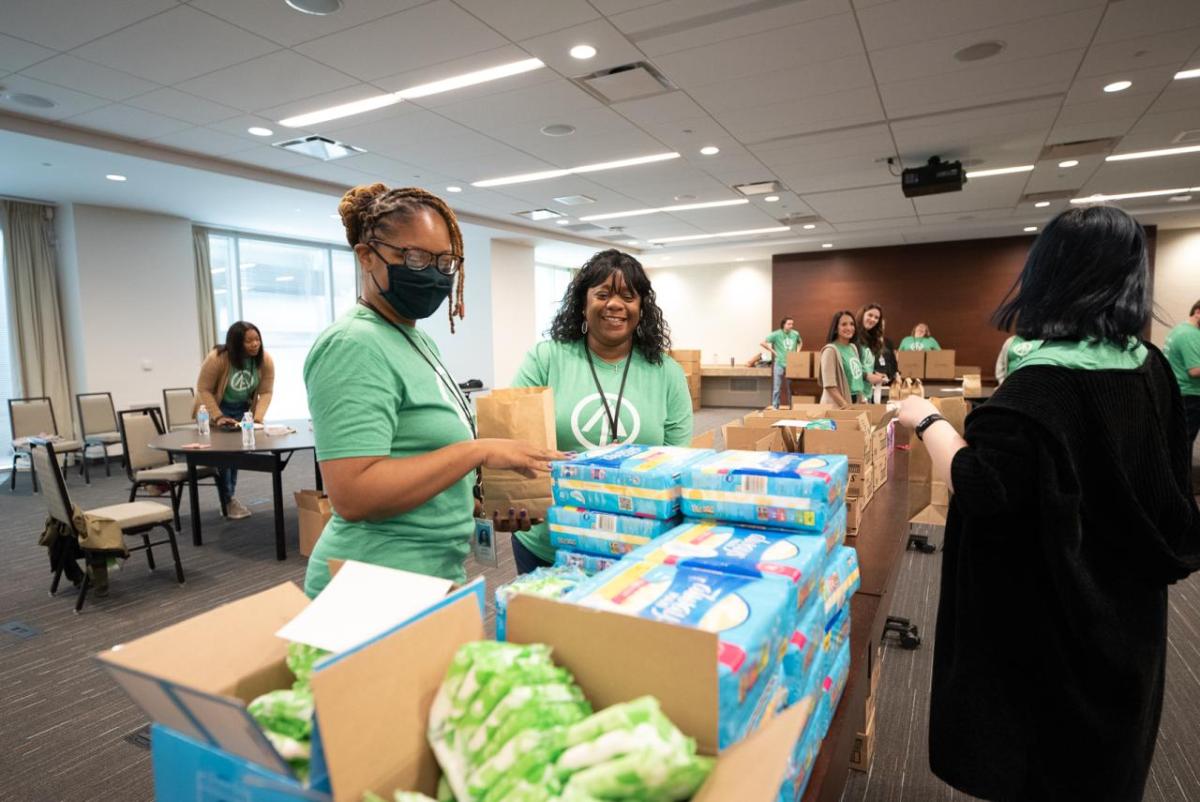 Women packaging menstrual health management supplies 