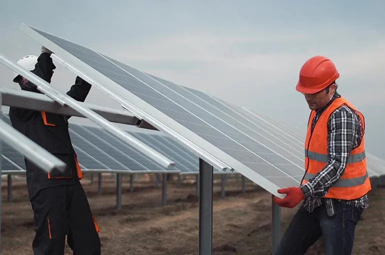 2 people install a solar panel