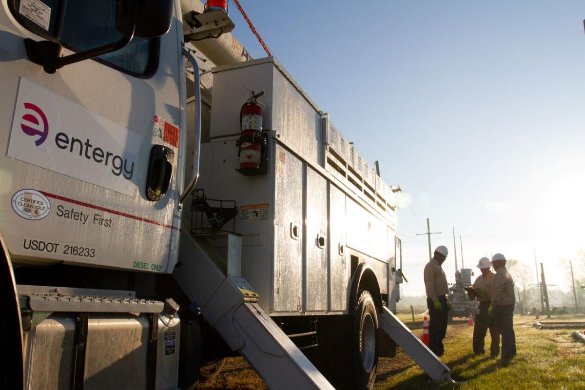 Entergy employees standing with truck