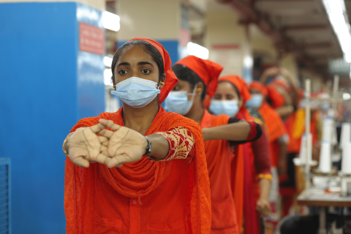 Healthy Working: Ergonomic Safety at Gildan Sewing operators stretching during an ergonomic pause in Gildan's facility