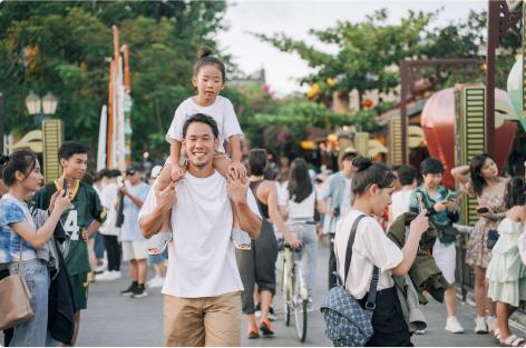 Man with a child on his shoulders.