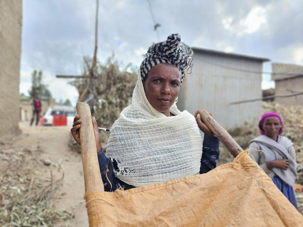 Kahsa with the traditional method of transporting patients - a traditional stretcher. All photos: Sarah Easter/CARE Woman with stretcher
