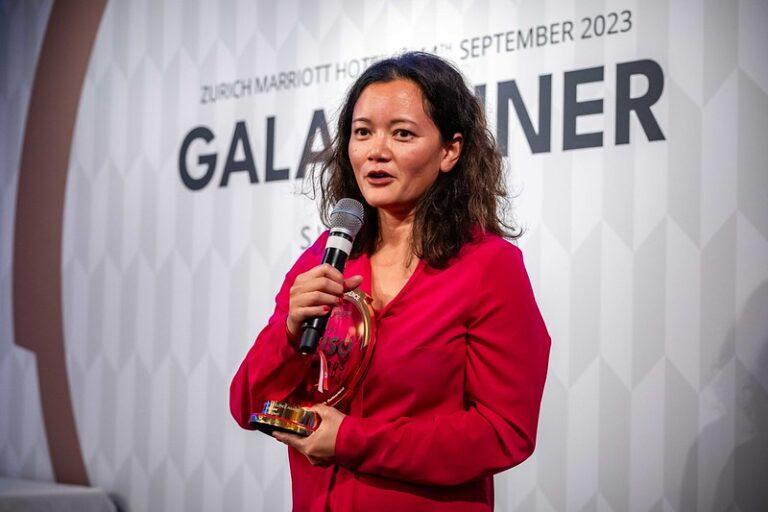 Person holding an award and giving a speech at the Global Cyber Conference 