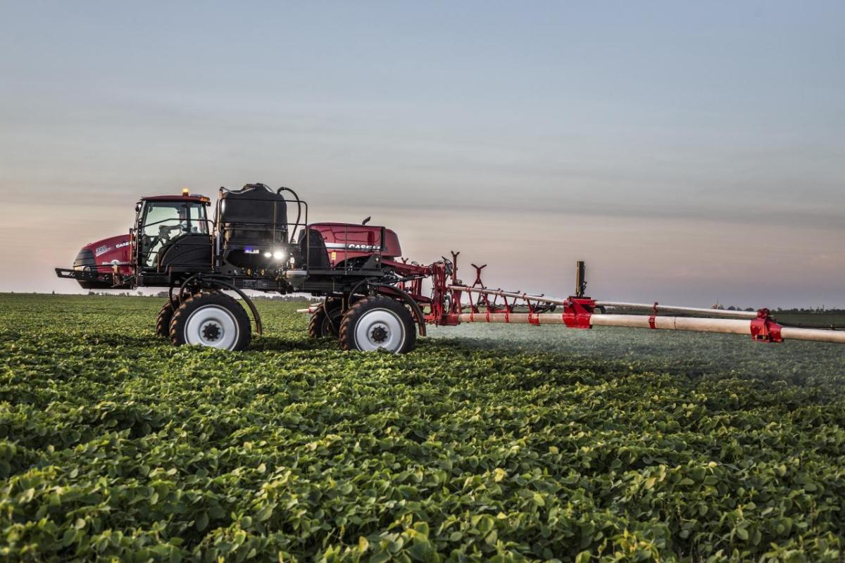 A large farming vehicle spraying a crop field