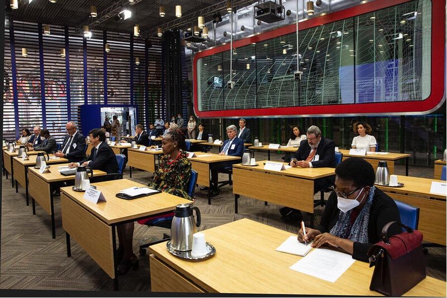 Several people seated at desks during FAO-CEMA Signing Ceremony