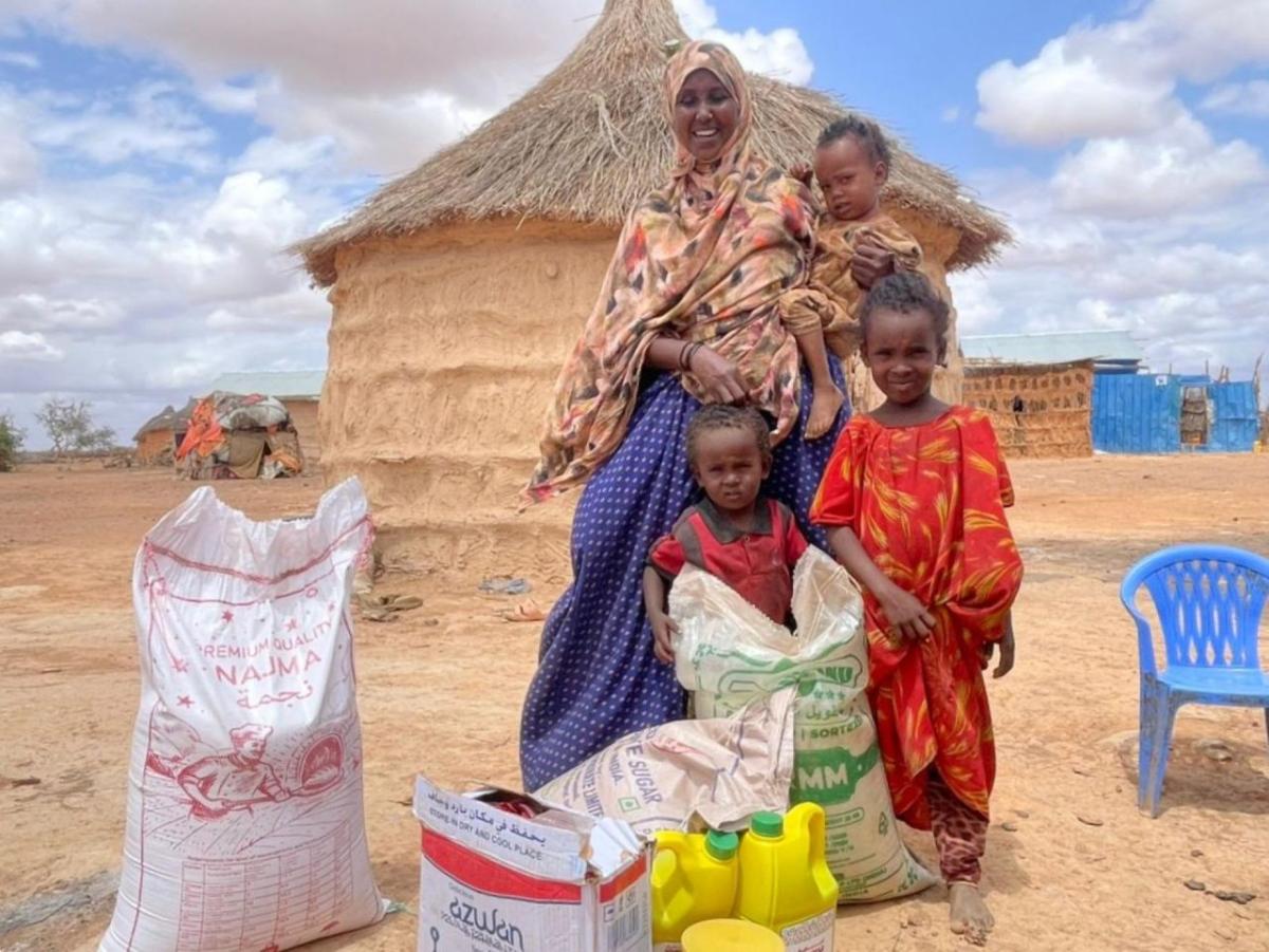 Abshiro and children with food purchased with cash assistance. 