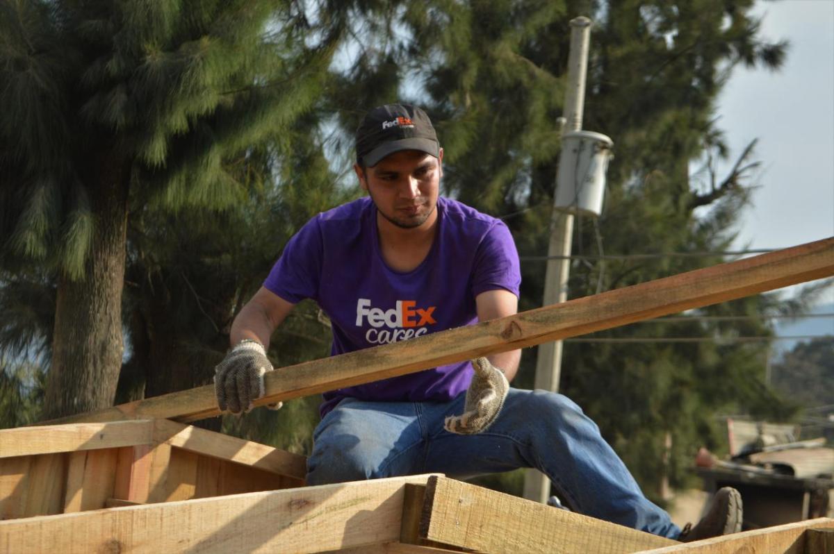 FedEx volunteer lifting building materials