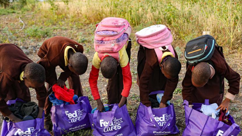 Children looking through purple fedex cares bags