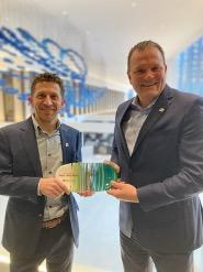 Fifth Third Senior Vice President Thomas Neltner, Enterprise Workplace Services Director and Chief Security Officer, and Fifth Third Vice President & Environmental Sustainability Leader Jeremy Faust (left), hold the Hamilton County R3Source Most Outstanding Partner award, which was made from recycled material.   