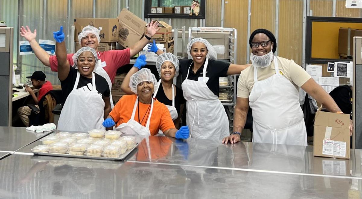 William Lessane, Tirhas Wubneh, Raquel Savoy, Vernetta Chambers, Mavis Haizel, and Dan Blitz food prepping for the Food & Friend Program. " "