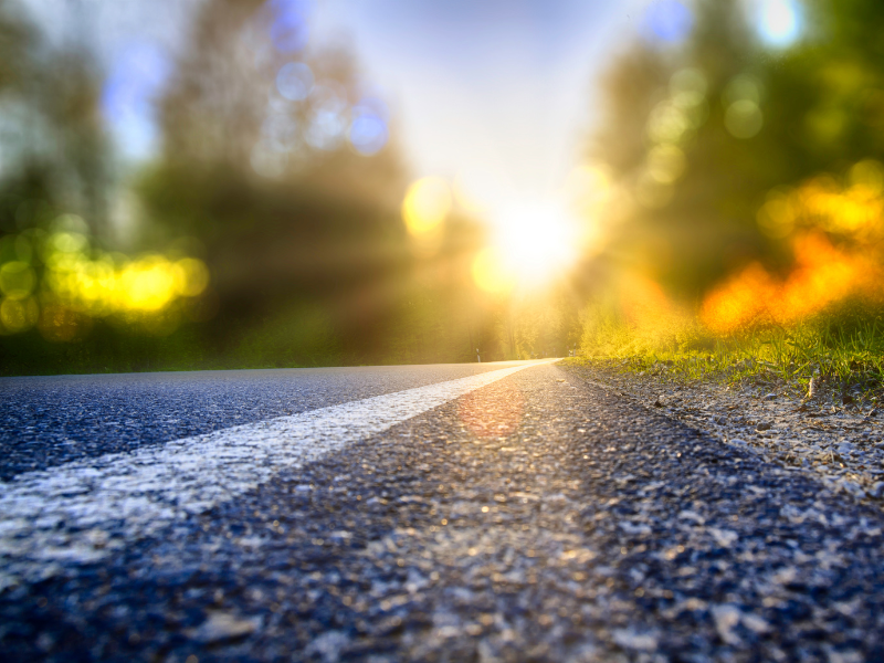 Paved road leads to green horizon