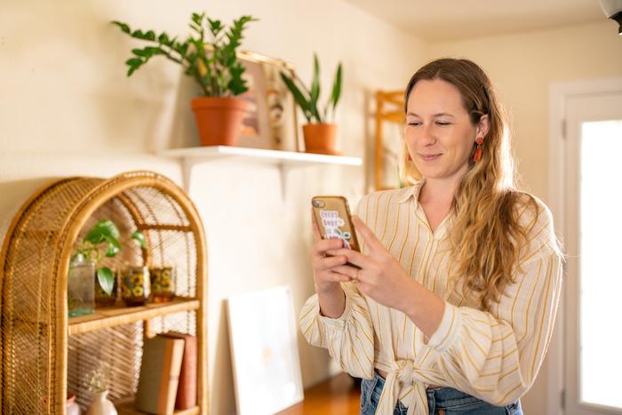 Sarah Small looking at a phone