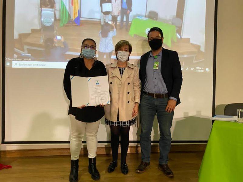 Griffith Foods Group of three people holding certification in front of projector
