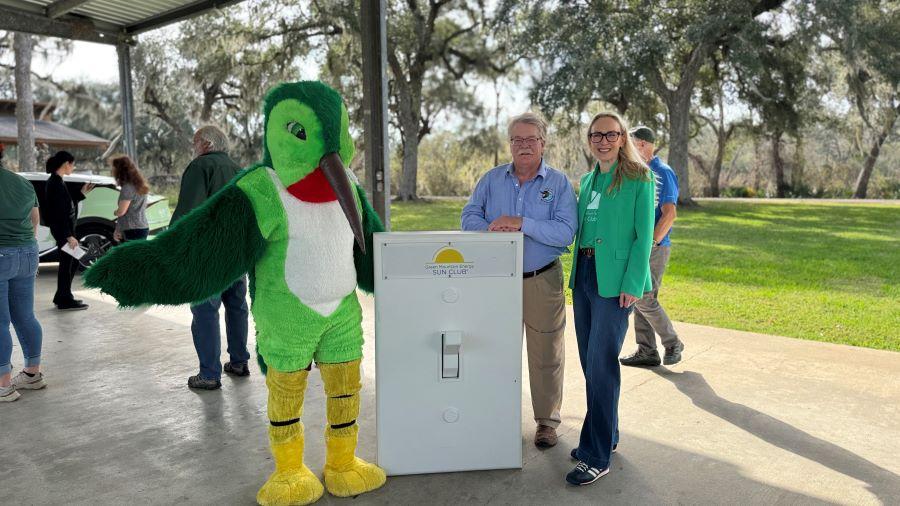 Gulf Coast Bird Observatory Executive Director, Martin Hagne, with mascot and Rebecca Emrick from Green Mountain Energy Sun Club at the "Flip the Switch" event on January 8.