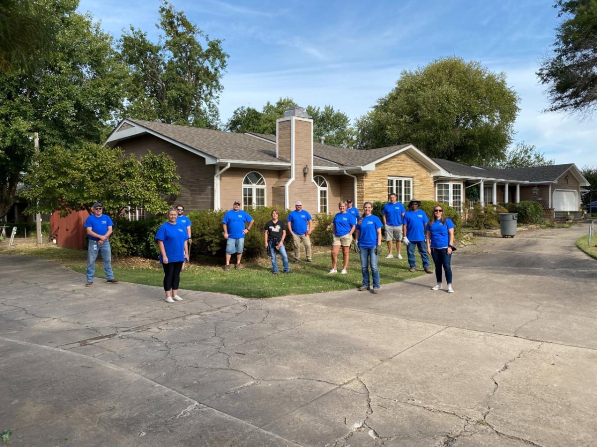 GP team posing in front of house