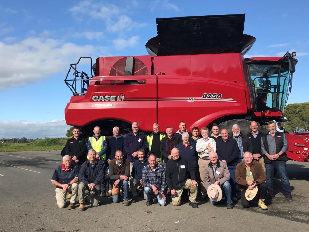 Group in front of red tractor