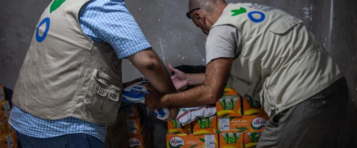 Two Action Against Hunger workers unloading boxes