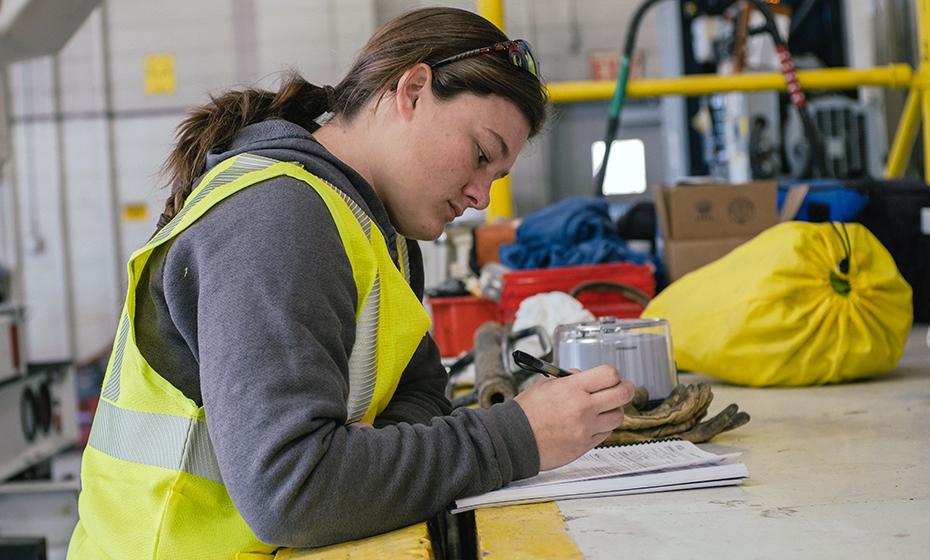 Georgia Hummel looking at paperwork on a work table.