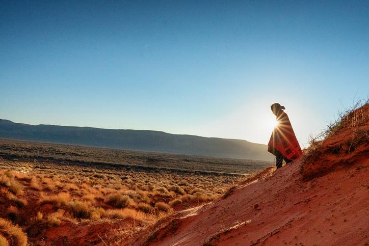 person on mountain at sunrise