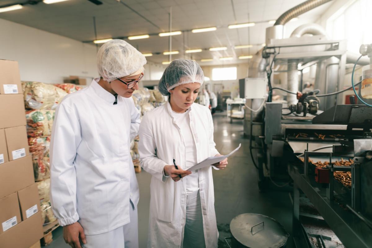 Two workers in food manufacturing facility