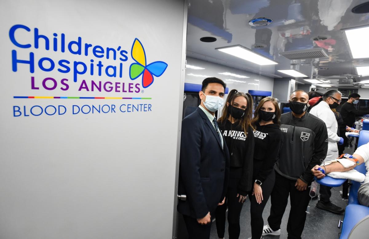 Group standing near sign reading, "Children's Hospital Los Angeles Blood Donation Center"
