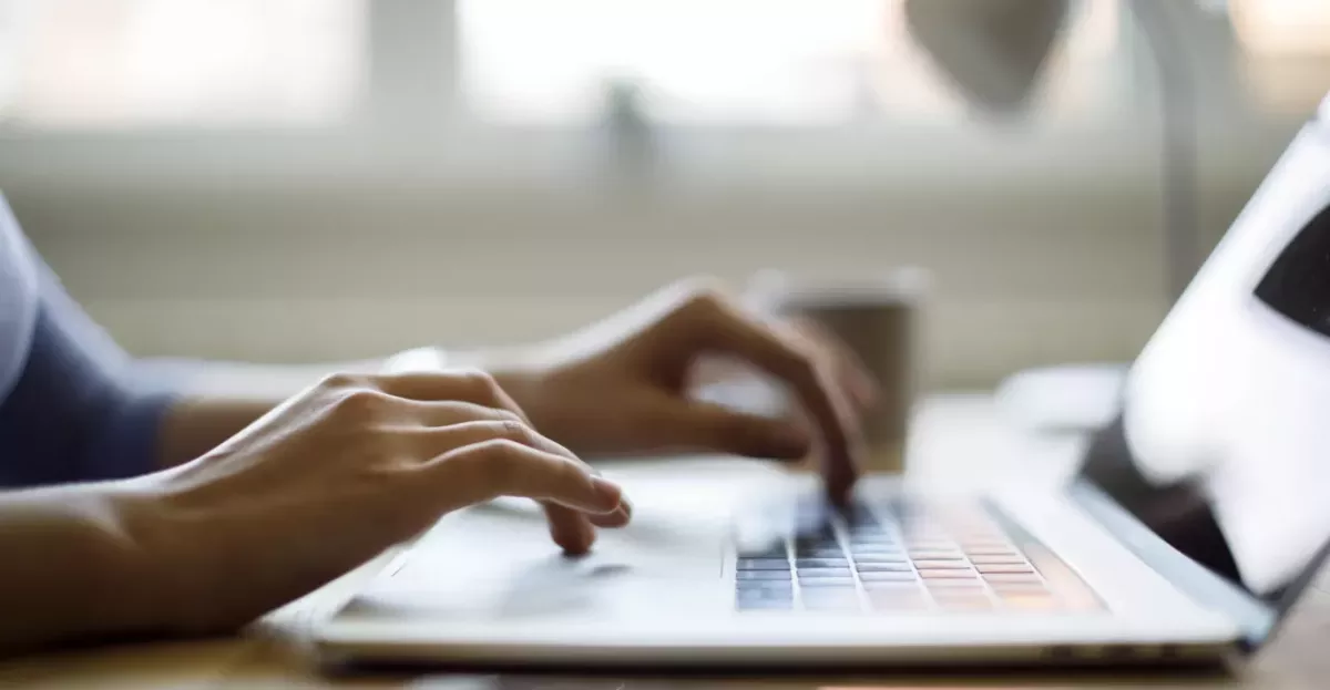 Fingers typing on a computer