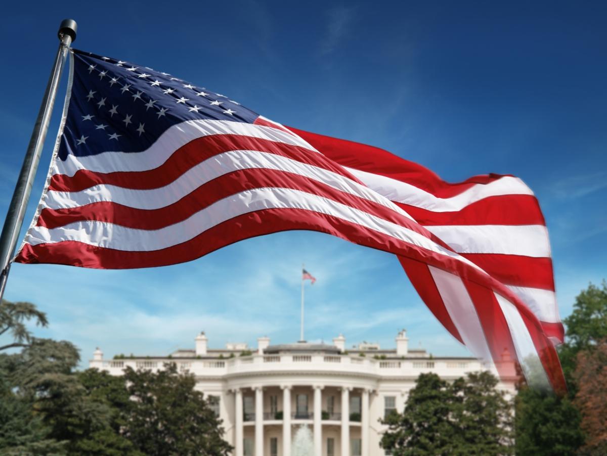 American flag waving over the White House