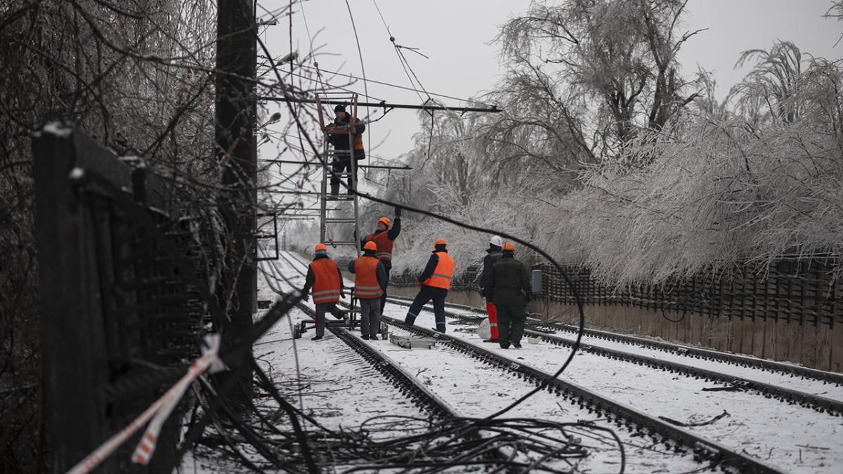 Power workers repair power lines in Ukraine in the snow.