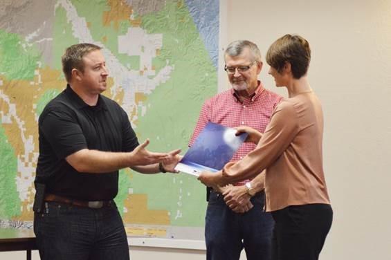 Freeport-McMoRan representatives Sean Wenham (left) and Conrad Parrish (center), present the Gila Watershed Partnership Director Melanie Tluczek with a check for $62,000.