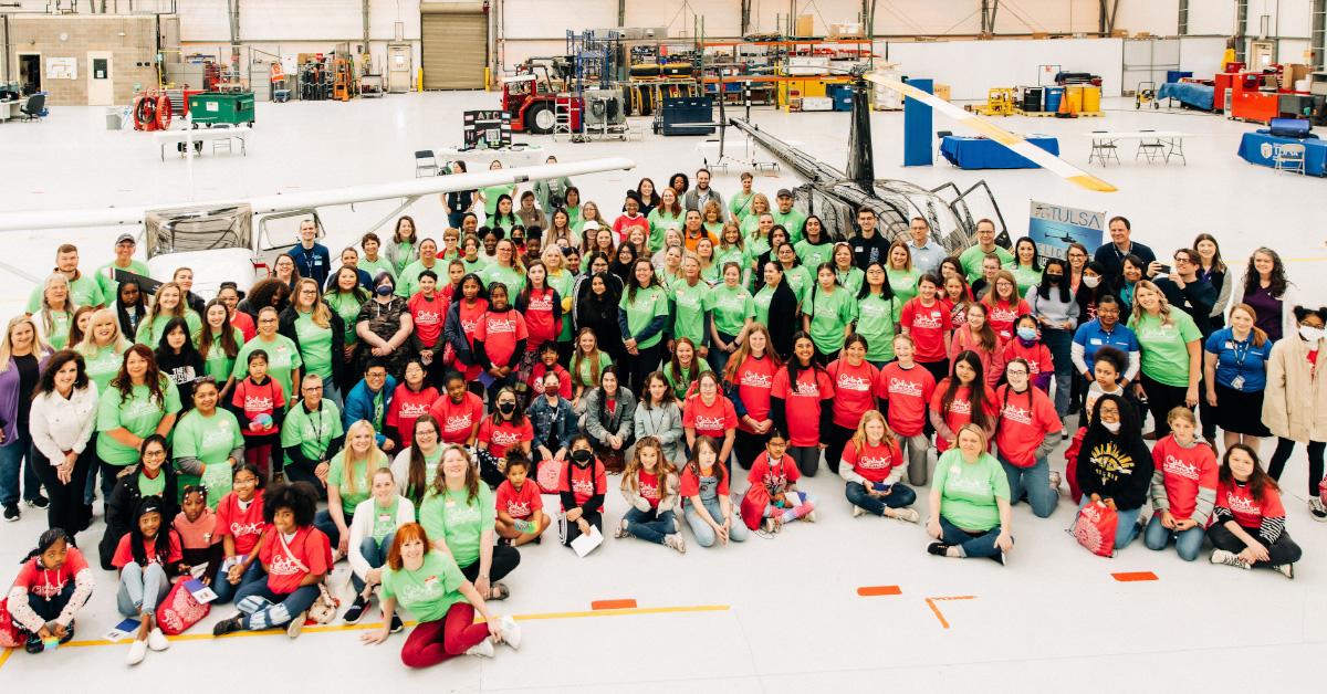 aerial view of large group of people inside a hangar