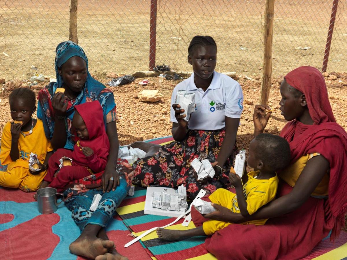 Celebrate Giving Tuesday with Action Against Hunger. // Photo by Peter Caton Mothers and children receiving care from Action Against Hunger worker