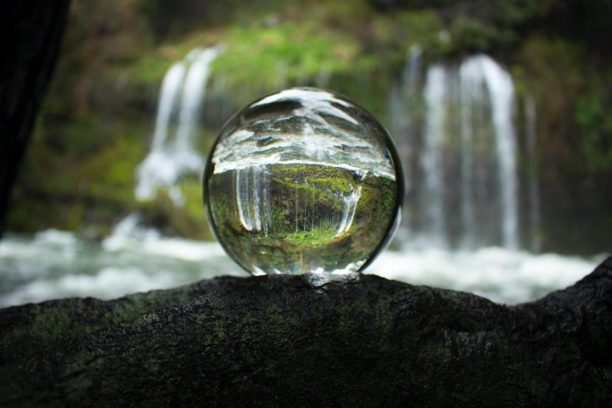 glass ball reflecting waterfall