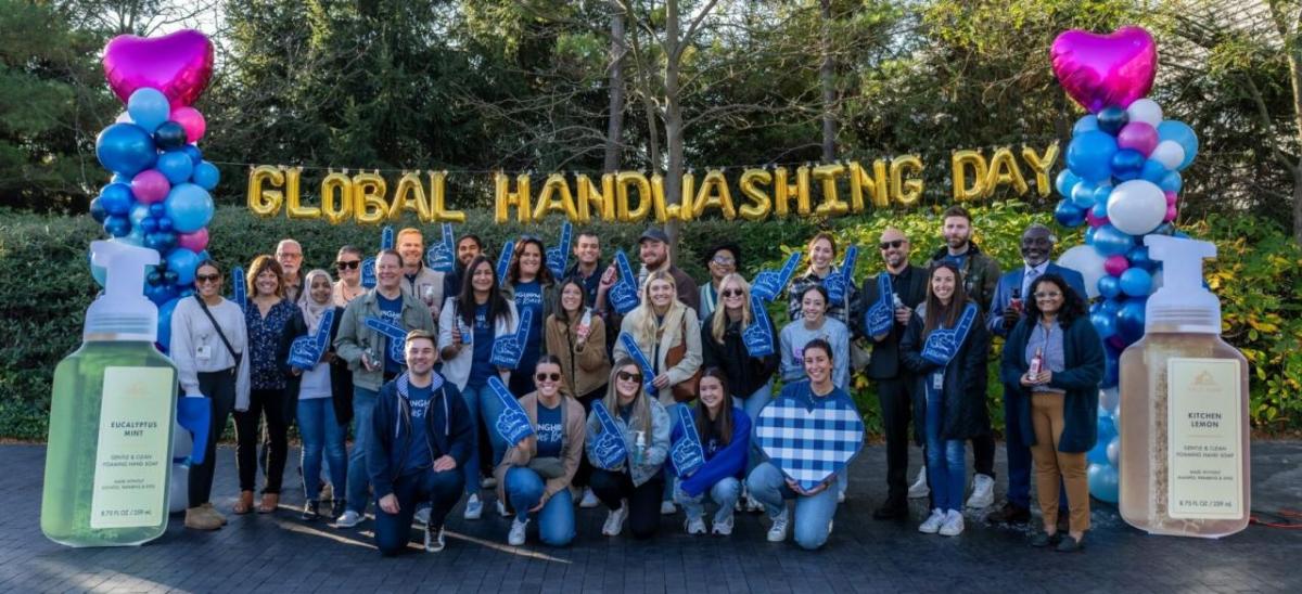 Group in front of Global Handwashing Day letter balloons