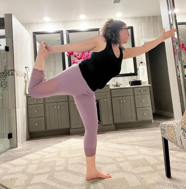 Sarah Smith performing yoga at home.
