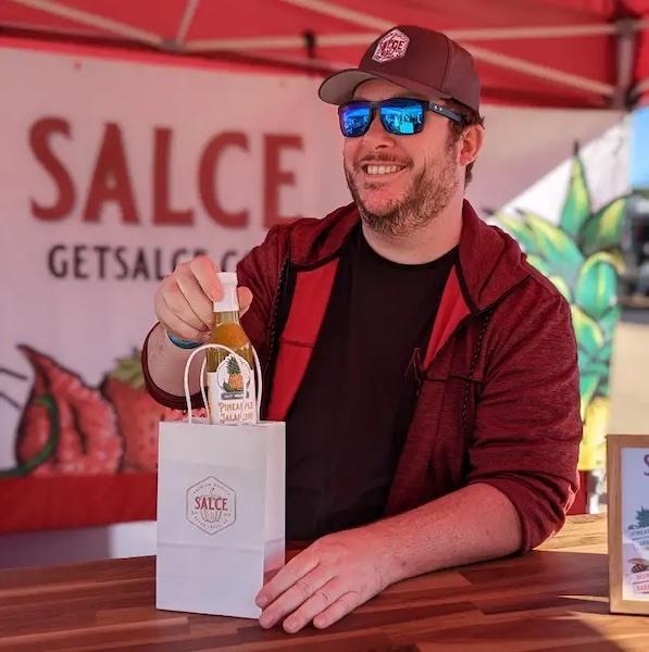 Jared holding a bottle of Salce sauce.