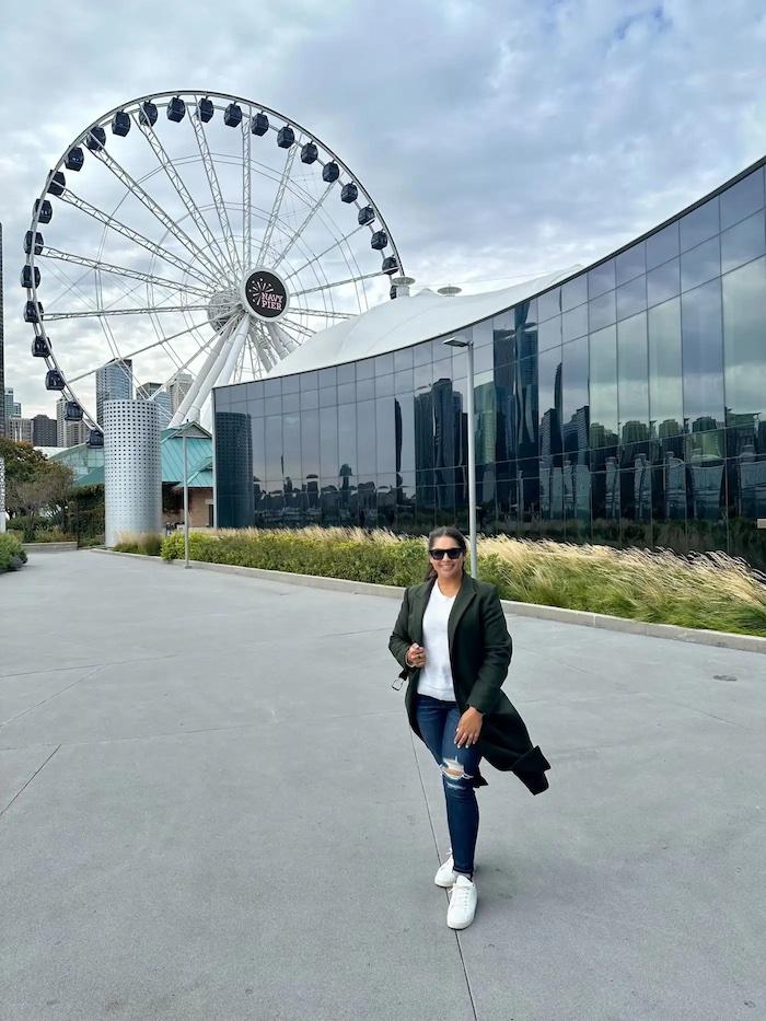 Shazia shown in front of a ferris wheel.