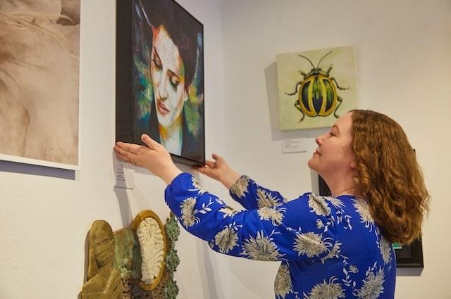 Catherine admiring a painting.A bit of tidying up in the gallery.