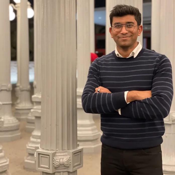 Adiyta Vikram in front of a column.