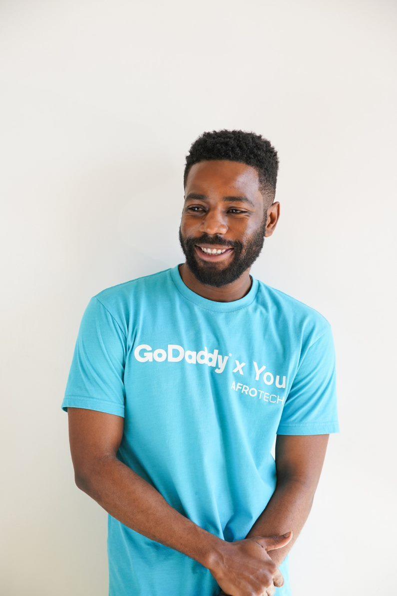 GoDaddy Employee wearing a t-shirt.