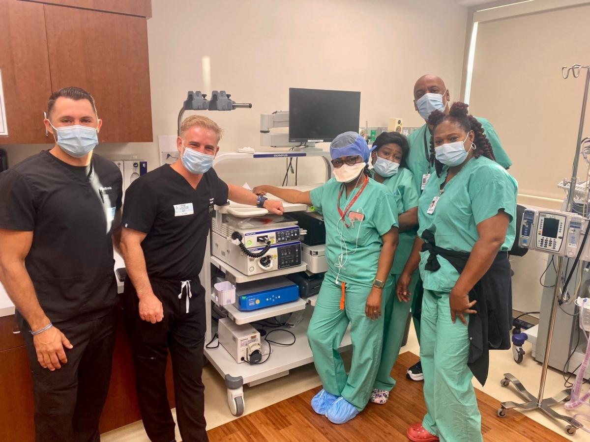 Healthcare workers standing by medical equipment