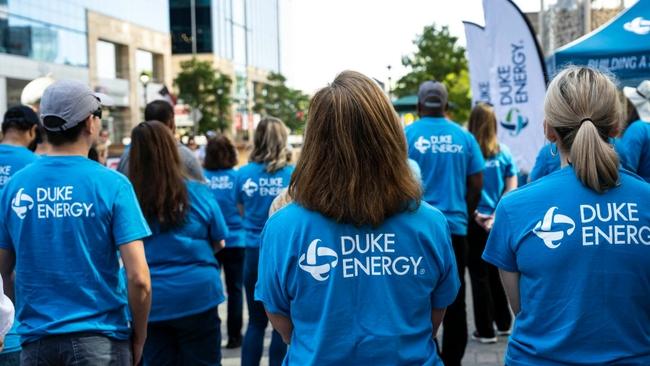 Group of people in Duke Energy t-shirts standing outside