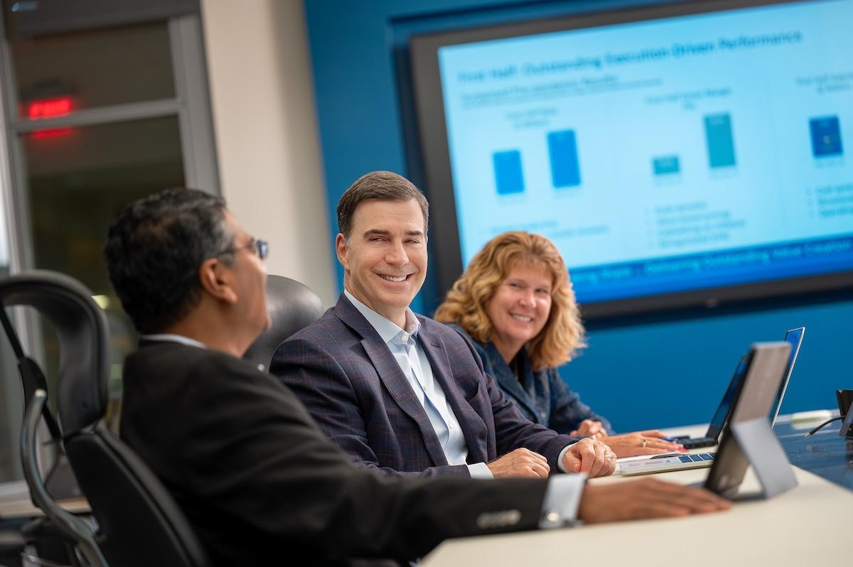 Wesco CEO John Engel (center) with other executives at Pittsburgh headquarters.