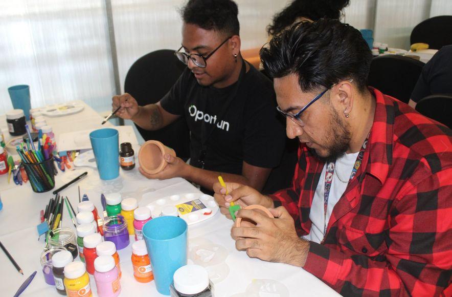 people painting items together at a table