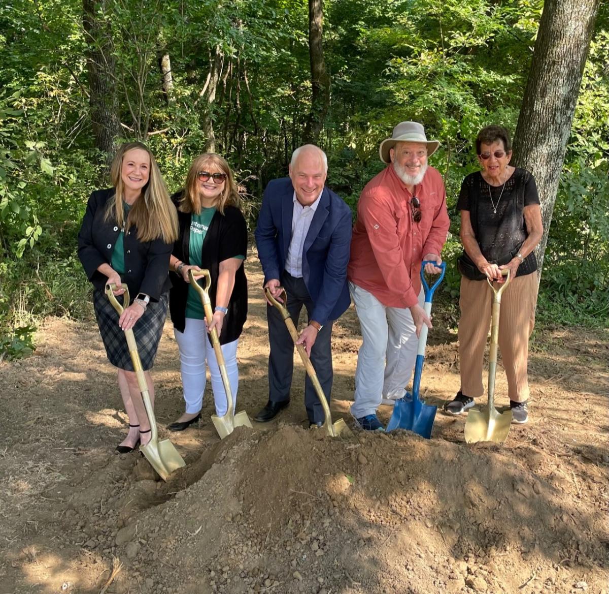 People posing with shovels at the Lichterman Nature Center