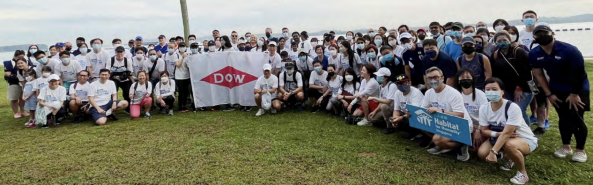 photo of a large group of people and people holding the dow logo 
