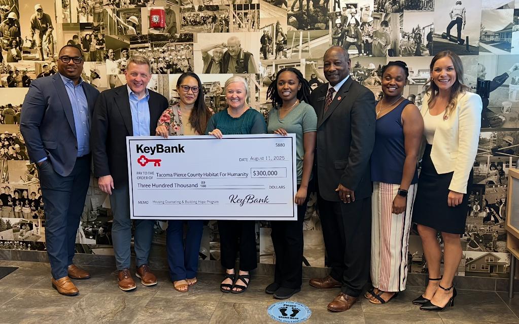 Representatives from KeyBank and Habitat for Humanity shown with a $300,000 grant check.