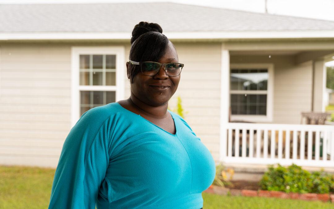 Melissa shown in front of her new home.