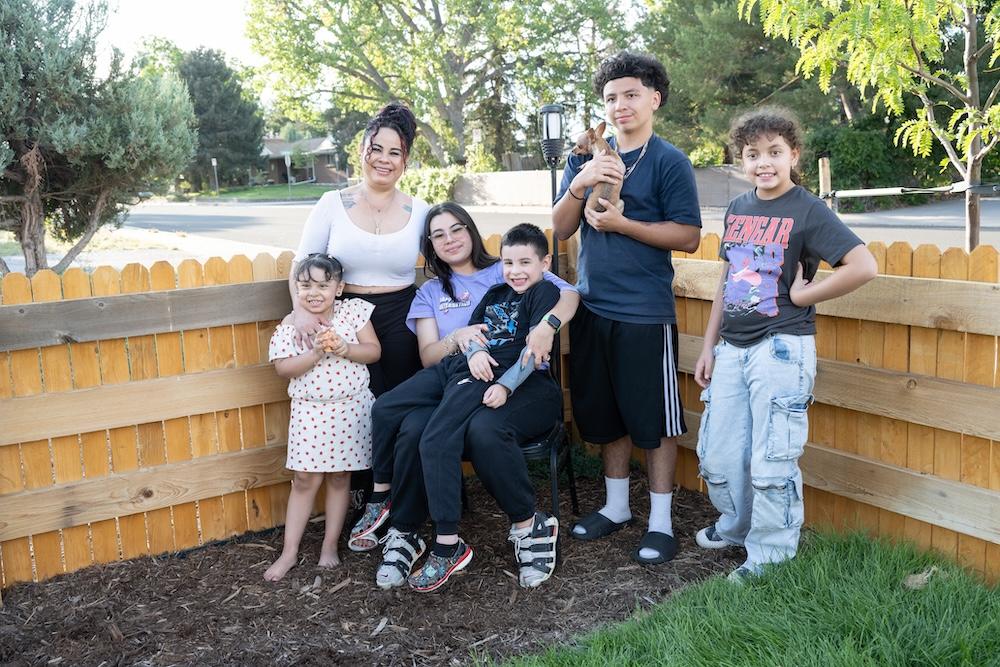 Family standing outside of house