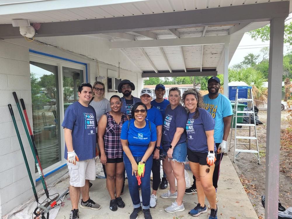 Group of volunteers standing together on porch