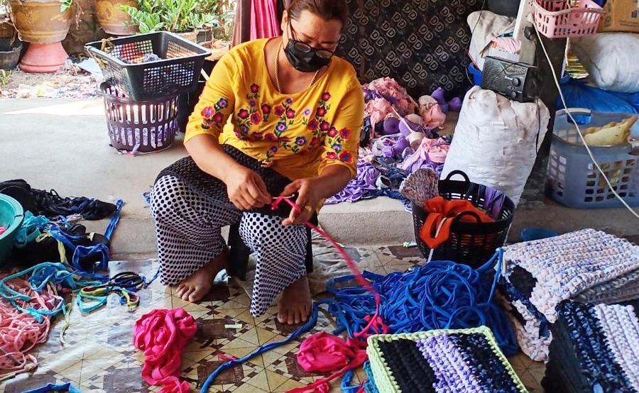 Thai woman weaving yarn.